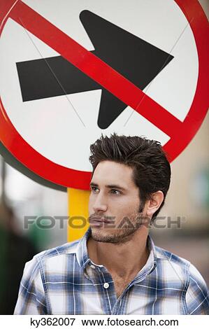 Handsome man thinking with no entry sign in the background View Large Photo Image Stock Photo - Handsome man thinking with no entry sign in the background. Fotosearch