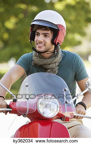 Man riding a scooter View Large Photo Image Picture - Man riding a scooter. Fotosearch