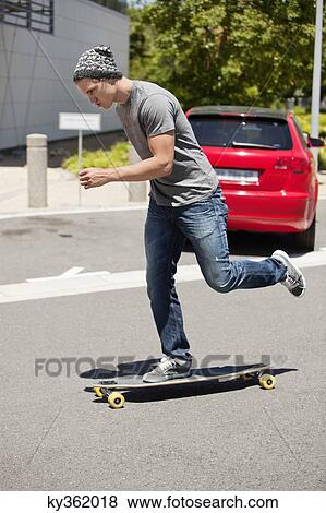 Man skateboarding on the road View Large Photo Image Stock Photo - Man skateboarding on the road. Fotosearch