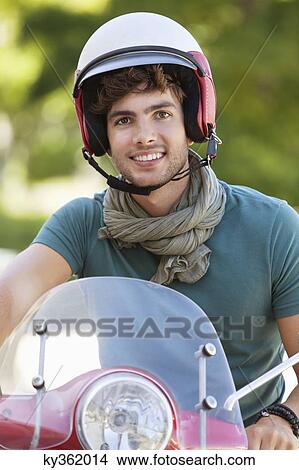 Portrait of a man riding a scooter View Large Photo Image Picture - Portrait of a man riding a scooter. Fotosearch