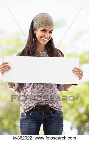 Portrait of a woman holding a blank placard View Large Photo Image Stock Image - Portrait of a woman holding a blank placard. Fotosearch