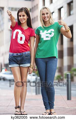 Portrait of beautiful female friends smiling and gesturing View Large Photo Image Stock Photography - Portrait of beautiful female friends smiling and gesturing. Fotosearch