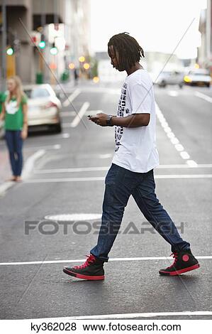 Side profile of a man text messaging on a mobile phone View Large Photo Image Stock Photo - Side profile of a man text messaging on a mobile phone. Fotosearch