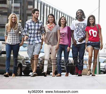 Smiling friends walking together View Large Photo Image Picture - Smiling friends walking together. Fotosearch