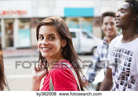 Smiling friends walking together View Large Photo Image Stock Photo - Smiling friends walking together. Fotosearch
