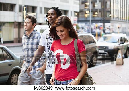 Smiling friends walking together View Large Photo Image Stock Photo - Smiling friends walking together. Fotosearch