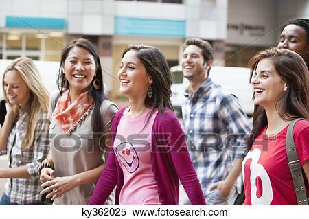 Smiling friends walking together View Large Photo Image Stock Photography - Smiling friends walking together. Fotosearch