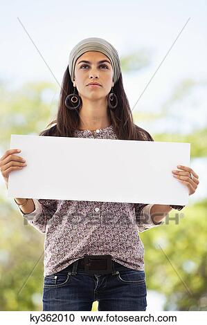 Woman holding a blank placard View Large Photo Image Stock Image - Woman holding a blank placard. Fotosearch
