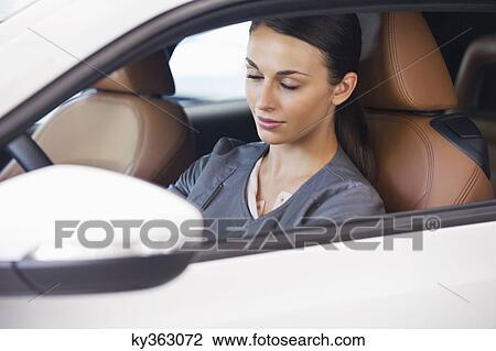 Beautiful young woman sitting in car with her eyes closed View Large Photo Image Stock Image - Beautiful young woman sitting in car with her eyes closed. Fotosearch