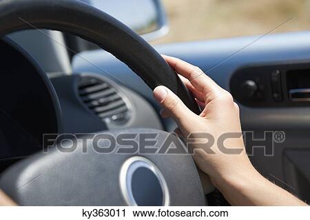 Close-up of a young woman's hand holding steering wheel View Large Photo Image Stock Image - Close-up of a young woman's hand holding steering wheel. Fotosearch