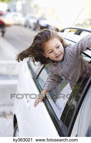 Cute little girl looking out of the car window View Large Photo Image Stock Image - Cute little girl looking out of the car window. Fotosearch