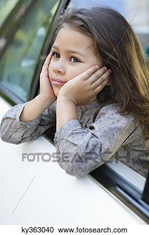 Cute little girl looking out of the car window View Large Photo Image Stock Image - Cute little girl looking out of the car window. Fotosearch