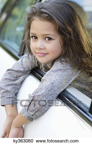 Cute little girl looking out of the car window View Large Photo Image Stock Image - Cute little girl looking out of the car window. Fotosearch