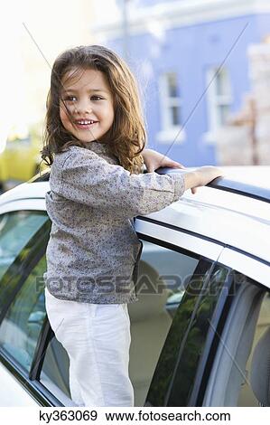 Cute little girl looking out of the car window View Large Photo Image Stock Photo - Cute little girl looking out of the car window. Fotosearch