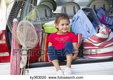 Cute little girl sitting in car trunk View Large Photo Image Stock Image - Cute little girl sitting in car trunk. Fotosearch