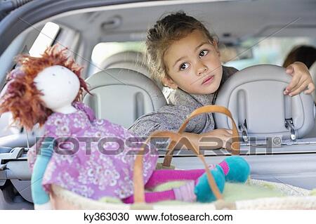 Cute little sitting in a car while mother driving the car View Large Photo Image Stock Image - Cute little sitting in a car while mother driving the car. Fotosearch