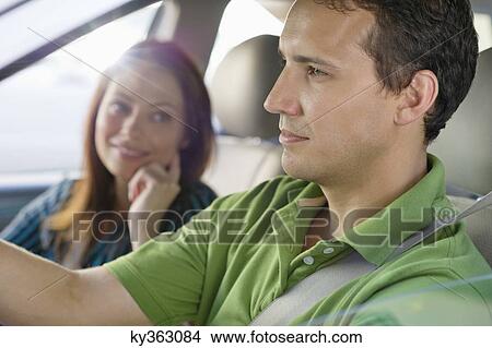 Happy couple driving a car View Large Photo Image Picture - Happy couple driving a car. Fotosearch