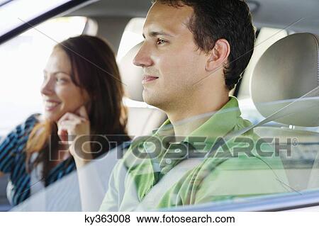 Happy couple driving a car View Large Photo Image Stock Photo - Happy couple driving a car. Fotosearch