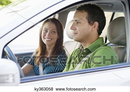 Happy couple driving a car View Large Photo Image Stock Photo - Happy couple driving a car. Fotosearch