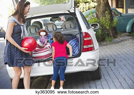 Little girl and her mother standing near a car View Large Photo Image Stock Photography - Little girl and her mother standing near a car. Fotosearch