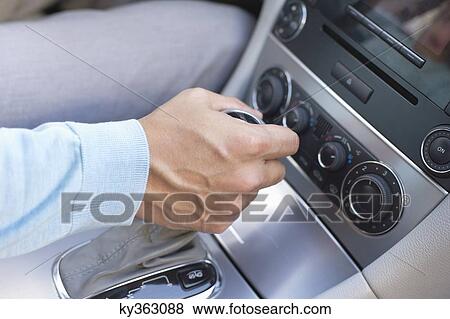 Stock Photo - Man shifting automatic car gear. Fotosearch
