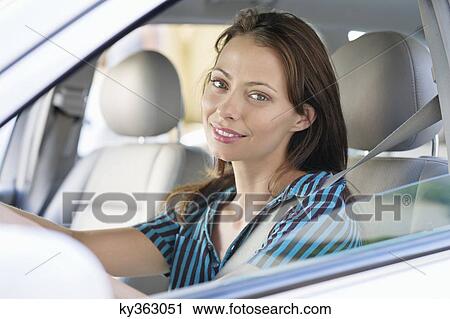 Portrait of a beautiful young woman sitting at driver's seat View Large Photo Image Stock Image - Portrait of a beautiful young woman sitting at driver's seat. Fotosearch