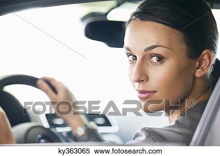 Portrait of a young woman taking a test drive View Large Photo Image Stock Photography - Portrait of a young woman taking a test drive. Fotosearch
