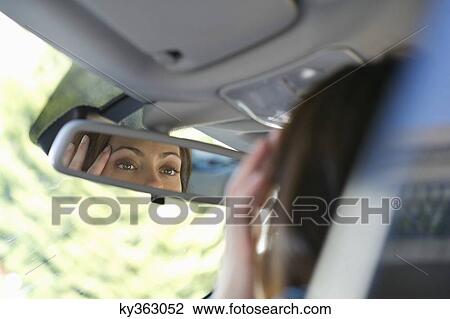 Reflection of a young woman eyes in rear-view mirror View Large Photo Image Stock Image - Reflection of a young woman eyes in rear-view mirror. Fotosearch