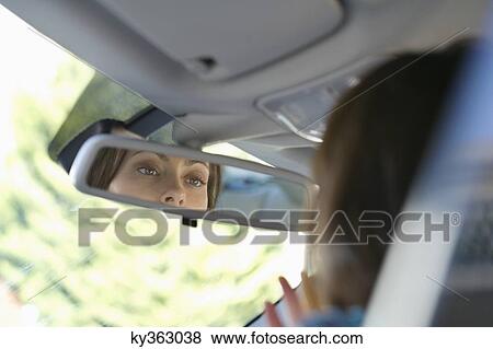 Reflection of a young woman eyes in rear-view mirror View Large Photo Image Stock Photo - Reflection of a young woman eyes in rear-view mirror. Fotosearch