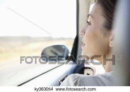 Young woman driving a car View Large Photo Image Picture - Young woman driving a car. Fotosearch