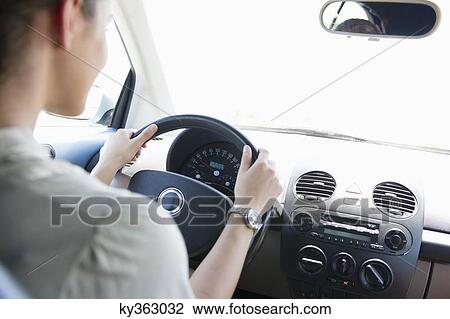 Young woman driving a car View Large Photo Image Stock Image - Young woman driving a car. Fotosearch