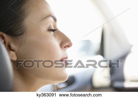 Young woman sleeping in a car View Large Photo Image Stock Image - Young woman sleeping in a car. Fotosearch