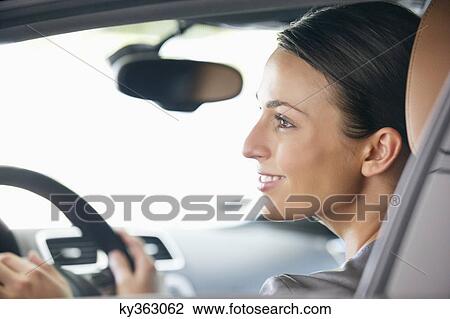 Young woman taking a test drive View Large Photo Image Stock Image - Young woman taking a test drive. Fotosearch