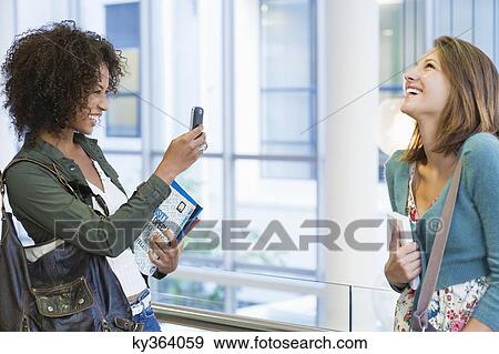 African American woman taking photos of her Caucasian friend View Large Photo Image Stock Photo - African American woman taking photos of her Caucasian friend. Fotosearch