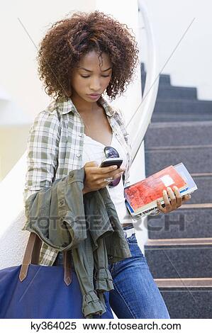 African American woman using mobile phone on university staircase View Large Photo Image Stock Photography - African American woman using mobile phone on university staircase. Fotosearch