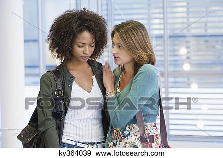 Caucasian woman consoling to an African American woman in university View Large Photo Image Stock Photo - Caucasian woman consoling to an African American woman in university. Fotosearch