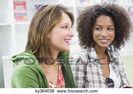Close-up of two university students in a library View Large Photo Image Stock Photo - Close-up of two university students in a library. Fotosearch