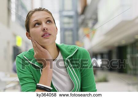 Contemplative woman looking up in a university lobby View Large Photo Image Stock Photo - Contemplative woman looking up in a university lobby. Fotosearch