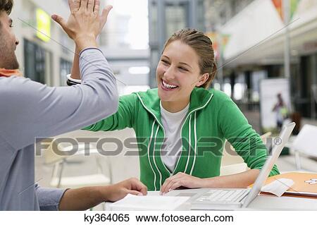 Friends giving each other high-five View Large Photo Image Stock Photography - Friends giving each other high-five. Fotosearch