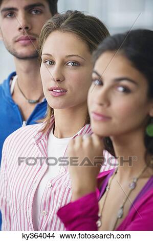 Portrait of three university students standing in a line with focus on a woman View Large Photo Image Picture - Portrait of three university students standing in a line with focus on a woman. Fotosearch