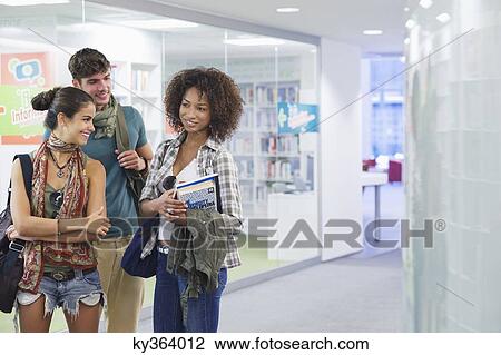 University students standing in a library View Large Photo Image Stock Image - University students standing in a library. Fotosearch