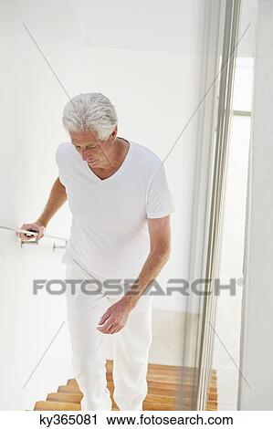 High angle view of a senior man moving up staircases View Large Photo Image Stock Image - High angle view of a senior man moving up staircases. Fotosearch