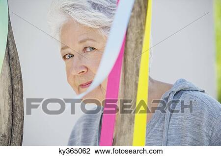 Portrait of a senior woman near a decorated tree View Large Photo Image Stock Image - Portrait of a senior woman near a decorated tree. Fotosearch