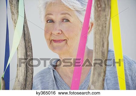 Portrait of a senior woman near a decorated tree View Large Photo Image Stock Photograph - Portrait of a senior woman near a decorated tree. Fotosearch