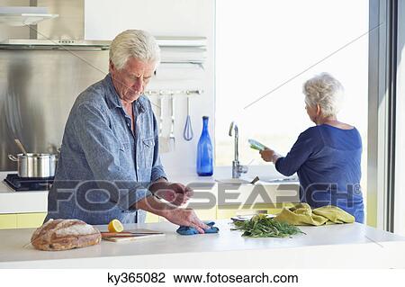 Senior couple cleaning the kitchen View Large Photo Image Stock Image - Senior couple cleaning the kitchen. Fotosearch