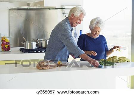 Senior couple cleaning the kitchen counter View Large Photo Image Stock Photo - Senior couple cleaning the kitchen counter. Fotosearch