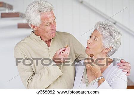 Senior couple eating chocolates View Large Photo Image Stock Image - Senior couple eating chocolates. Fotosearch