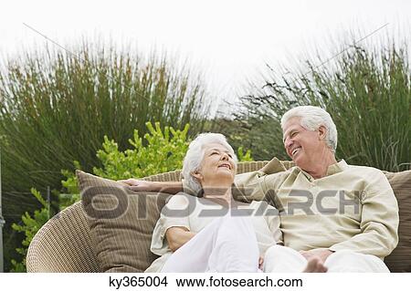 Senior couple sitting in a wicker couch View Large Photo Image Picture - Senior couple sitting in a wicker couch. Fotosearch