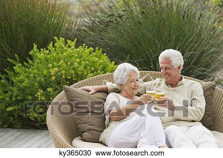 Senior couple toasting with wine glasses View Large Photo Image Stock Image - Senior couple toasting with wine glasses. Fotosearch