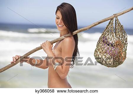Close-up of a young woman carrying net bag on shoulder View Large Photo Image Stock Photo - Close-up of a young woman carrying net bag on shoulder. Fotosearch